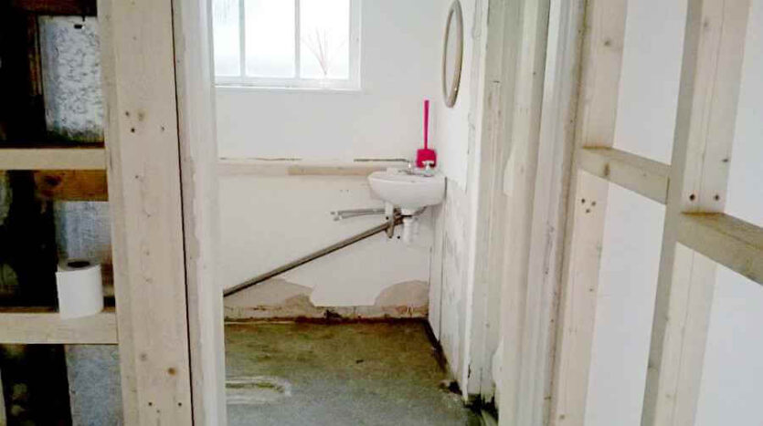 entrance into the kitchen and WC on the left with new lobby wall studwork on the right