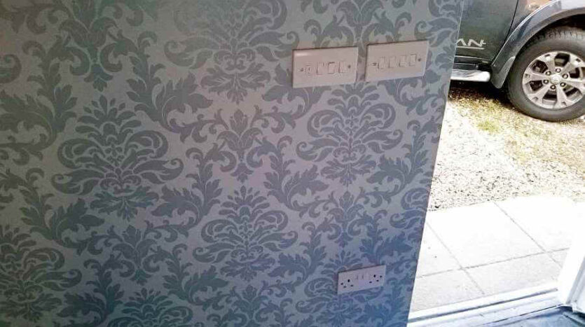 wallpaper around light switches on feature wall