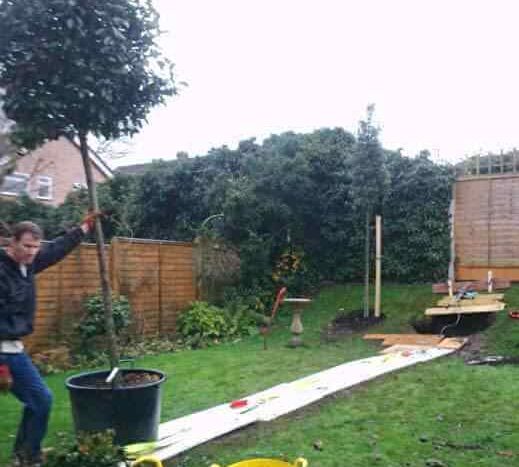 winching the containers up the garden into the tree pits
