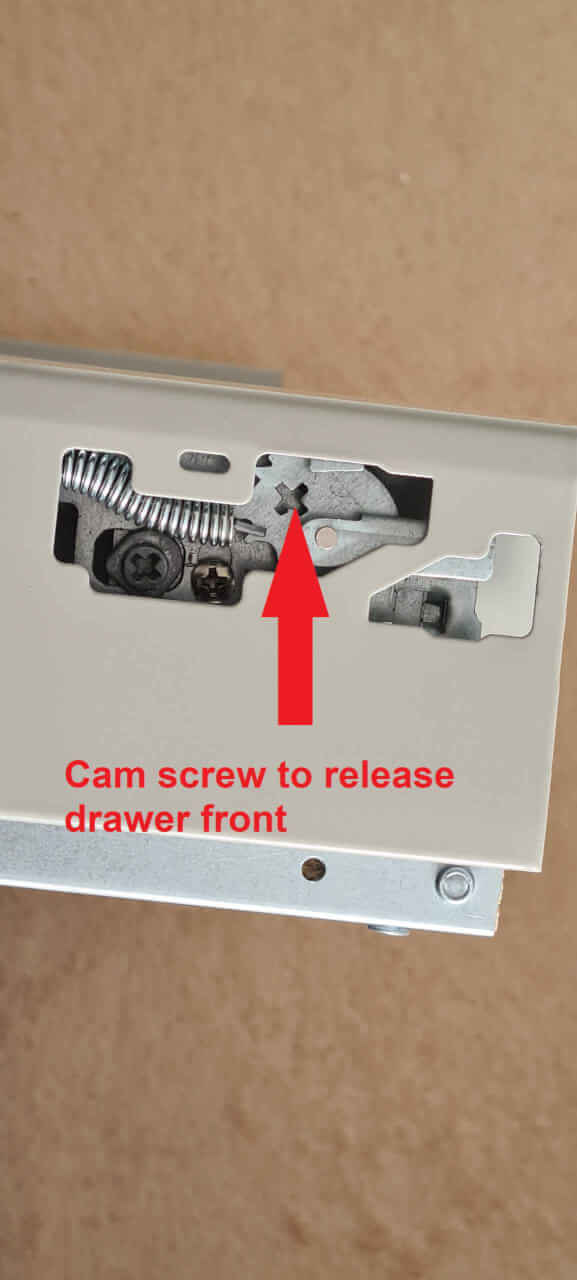 Drawer cam screw used to release drawer front.