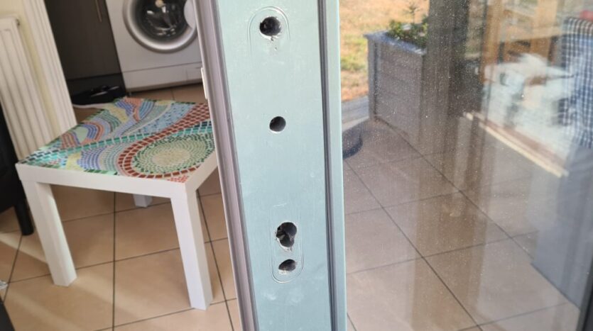holes drilled in door for handle scaled