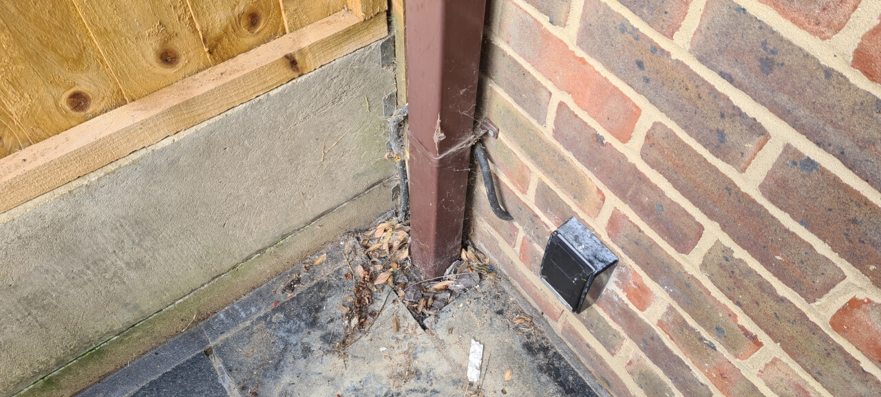 Old downpipe as it goes into the ground adaptor for connection to the 110mm drainage pipe