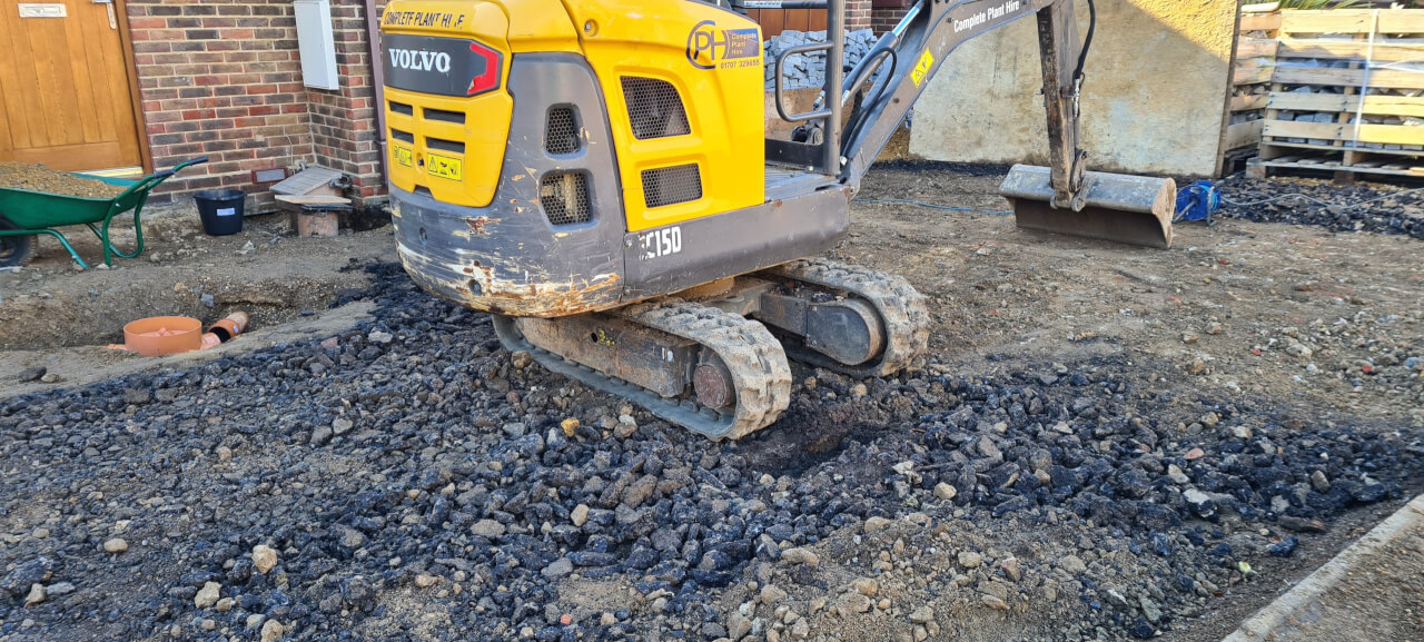 Digger spreading crush over the site