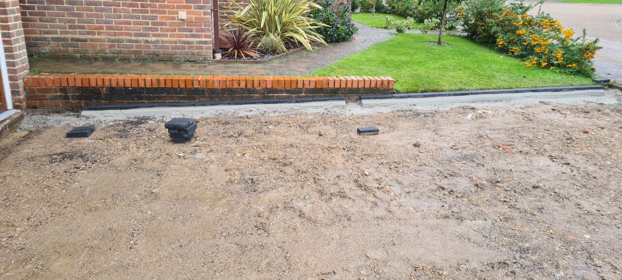 Entire site levelled and edging brick set in sharpsand and cement haunching