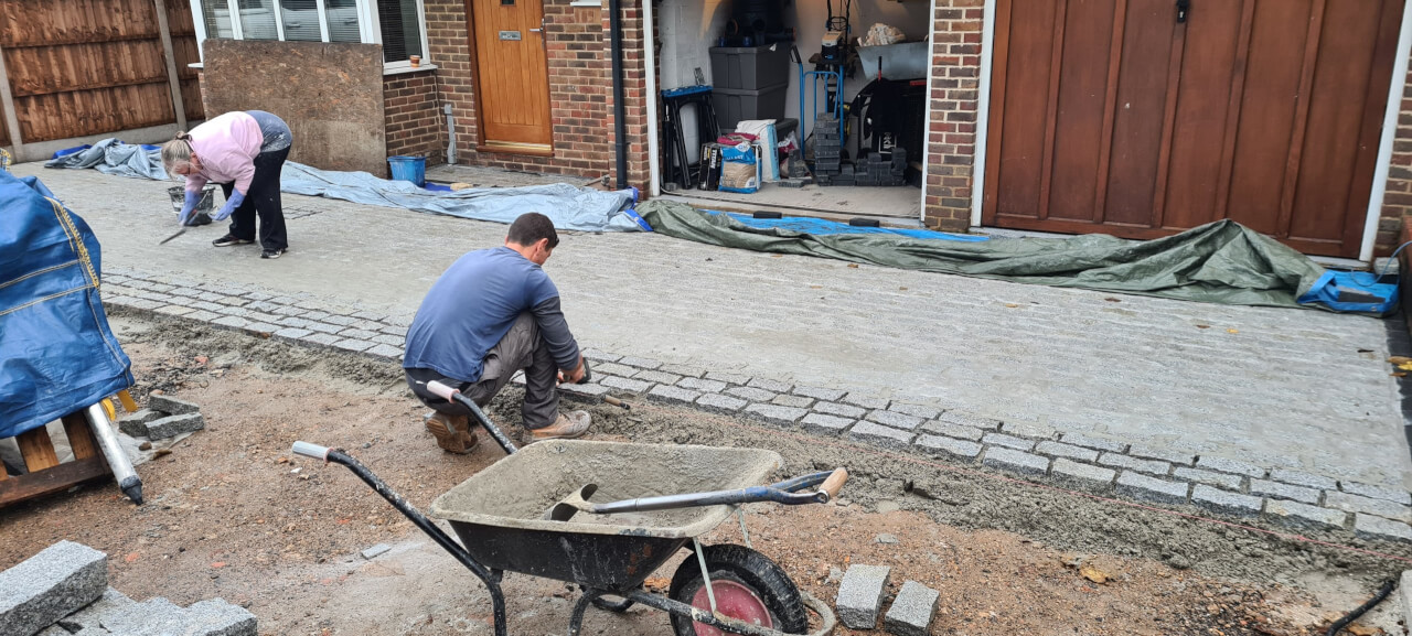 Laying cobbles and striking off the grout