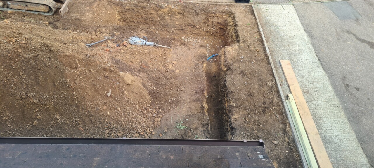 Soak away pit and newly dug trench for drainage pipe