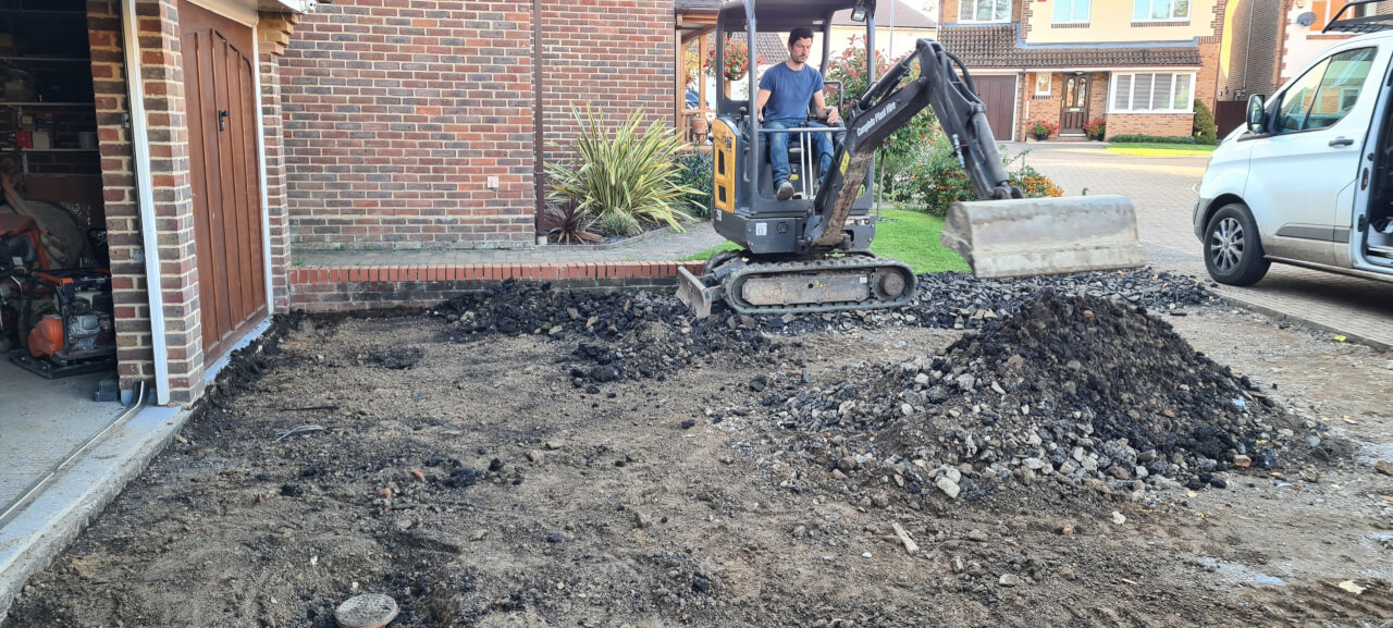 Spreading the crush around the site with the digger