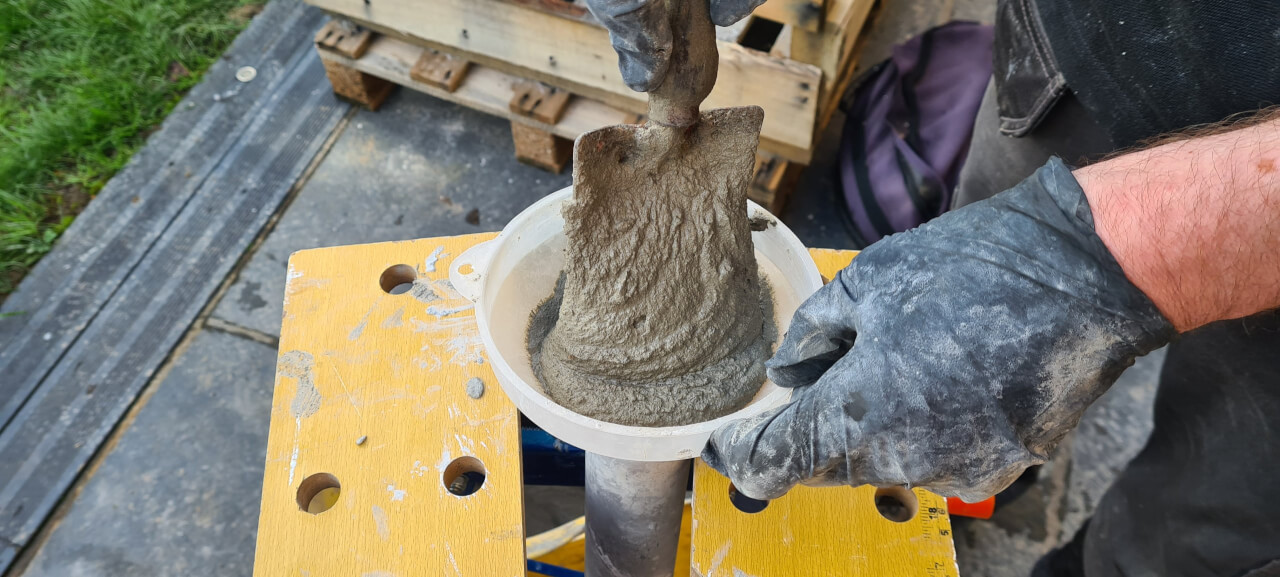 Trowling mortar into the grout gun