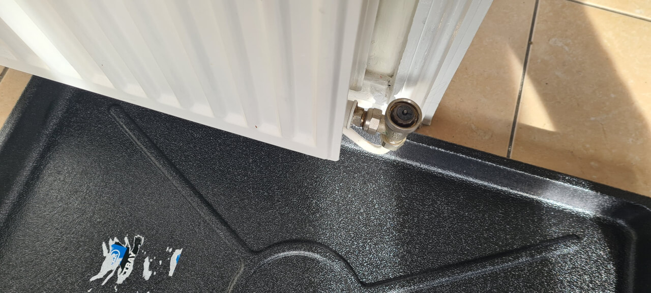 tray for catching drips from radiator