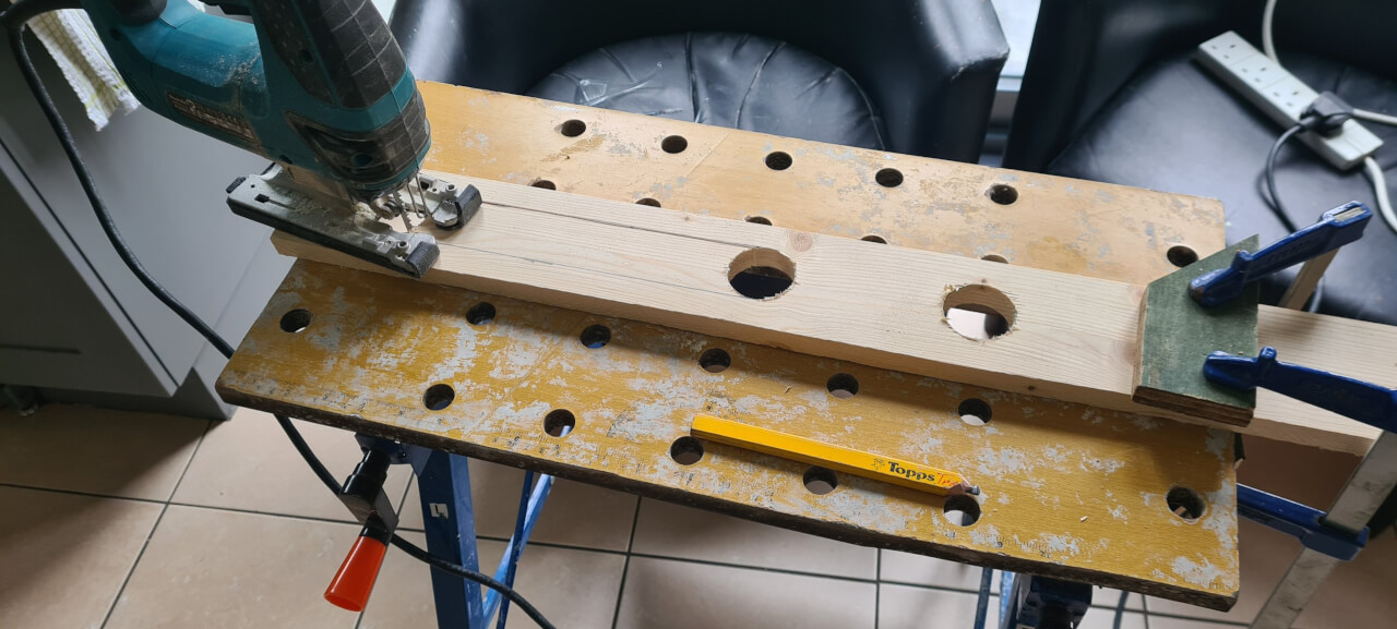 Using a jigsaw to cut the air holes in the seat back top cover strip