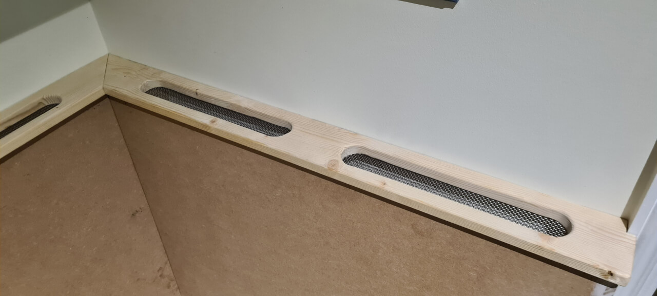 Wire mesh tacked to the underside of the seat back cover strips to protect the air vent holes