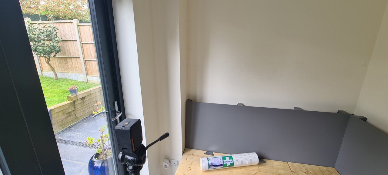 Checking the walls for square with a laser level
